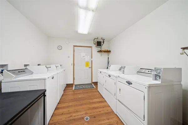 a utility room with cabinets washer and dryer