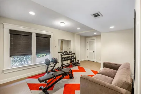 a living room with furniture a flat screen tv and a window