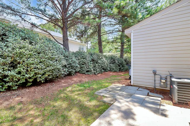 a view of a backyard with large trees