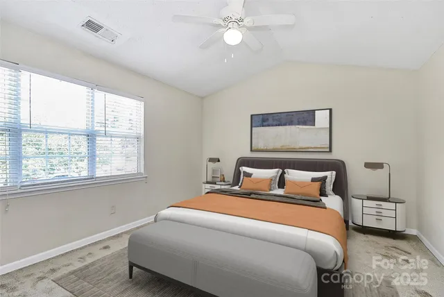 a bedroom with a large bed and a window