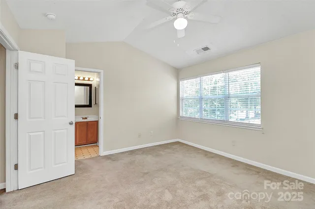 an empty room with windows and cabinet