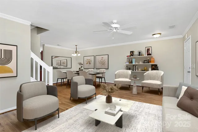 a living room with furniture and a chandelier