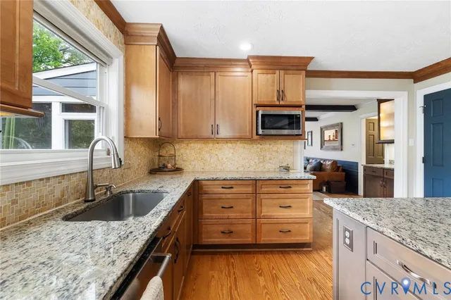 a kitchen with a stove a sink and a microwave