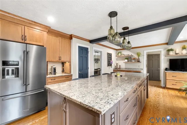 a kitchen with stainless steel appliances granite countertop a sink refrigerator and microwave