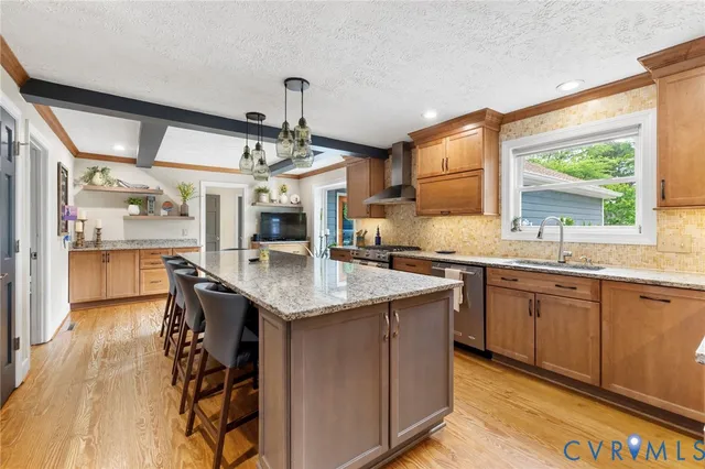 a kitchen with stainless steel appliances granite countertop a sink and a wooden cabinets