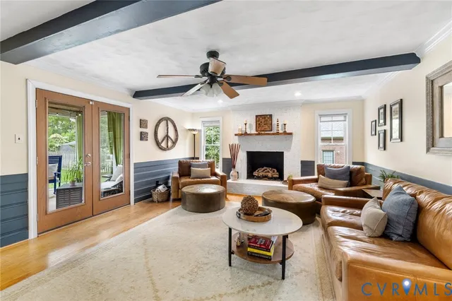 a living room with furniture a fireplace and a window