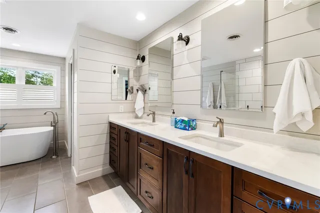 a bathroom with a bathtub and a window