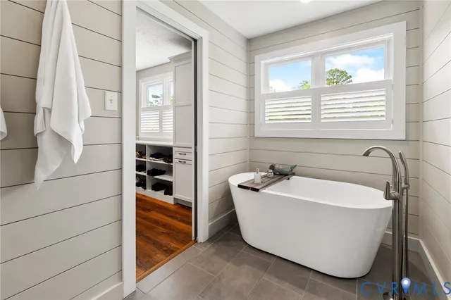 a large bathroom with a double vanity sink a mirror and shower
