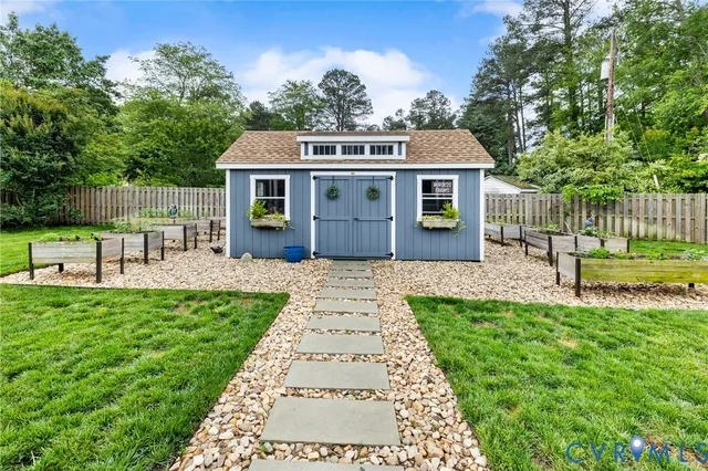 a garden with a bench in front of it