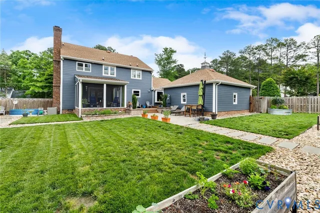 a view of backyard of house with green space