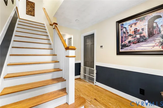 a view of entryway and hall with wooden floor