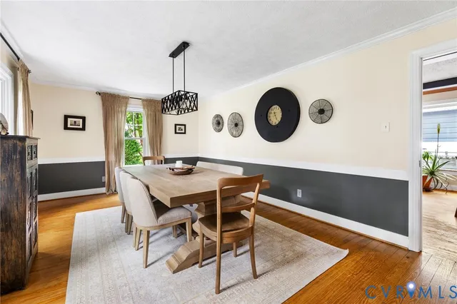 a dining room with furniture and a large window
