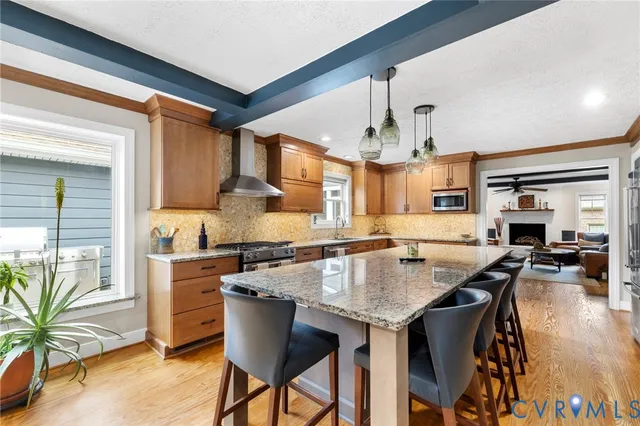a kitchen with granite countertop a table chairs stove and cabinets