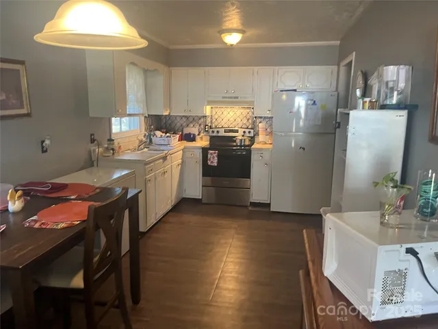 a kitchen with stainless steel appliances granite countertop a sink a stove a refrigerator and island