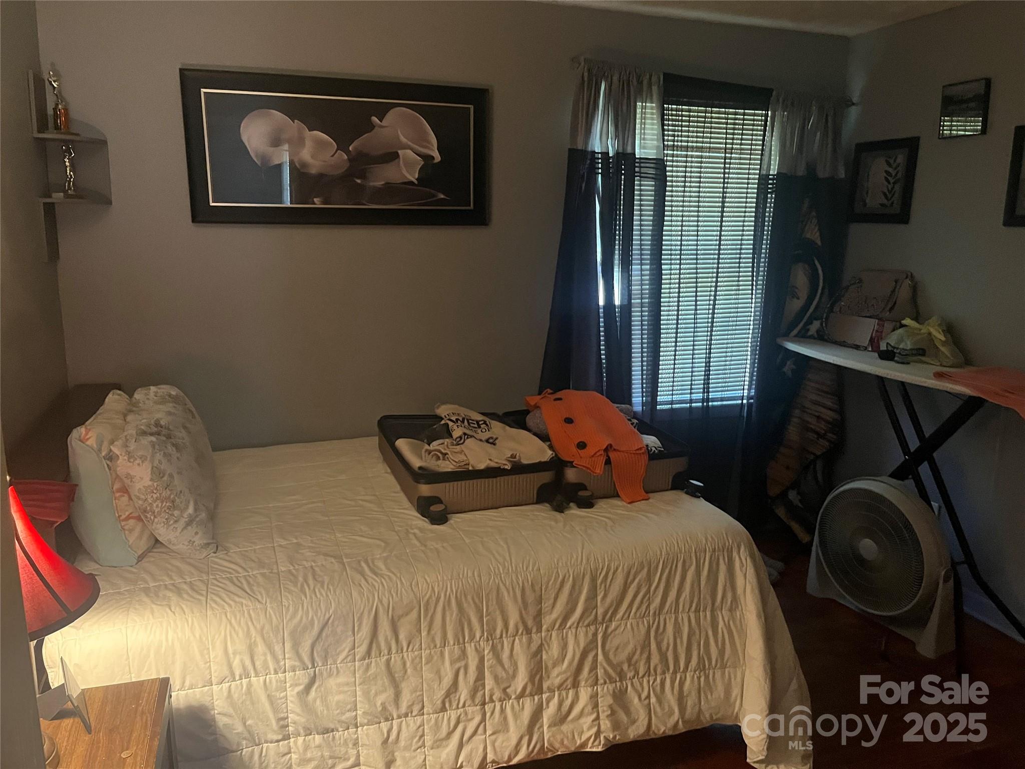 512 Produce Market Road Laurinburg, NC 28352 - Photo 6 of 10 a bedroom with a bed and wooden floor