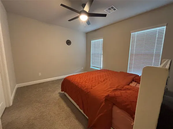 a bedroom with a bed and window