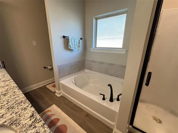 a bath tub sitting next to a white sink