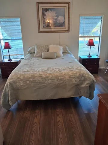 a bedroom with a bed and a painting on the wall