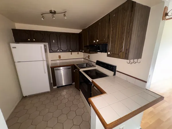 a kitchen with a sink a stove and refrigerator