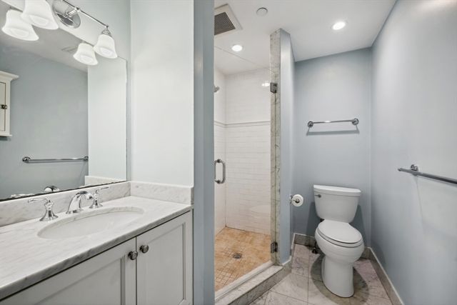 a bathroom with a toilet sink and shower
