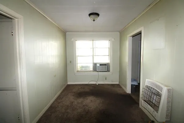 a view of room with window and a wooden floor