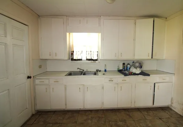 a kitchen with white cabinets
