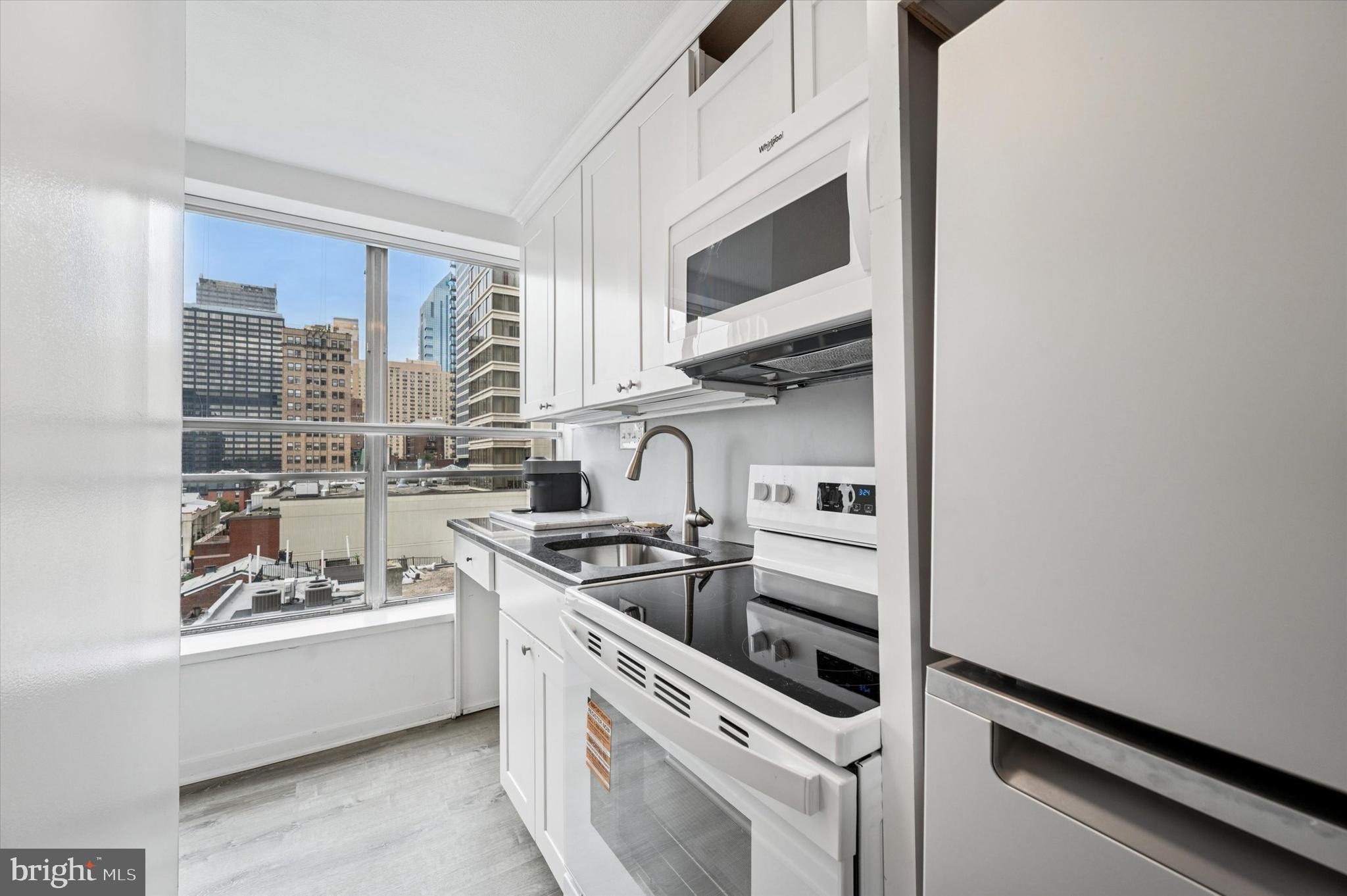 224 West Rittenhouse Square, Unit 715A Philadelphia, PA 19103 - Photo 12 of 47 a kitchen with stainless steel appliances a sink and a stove