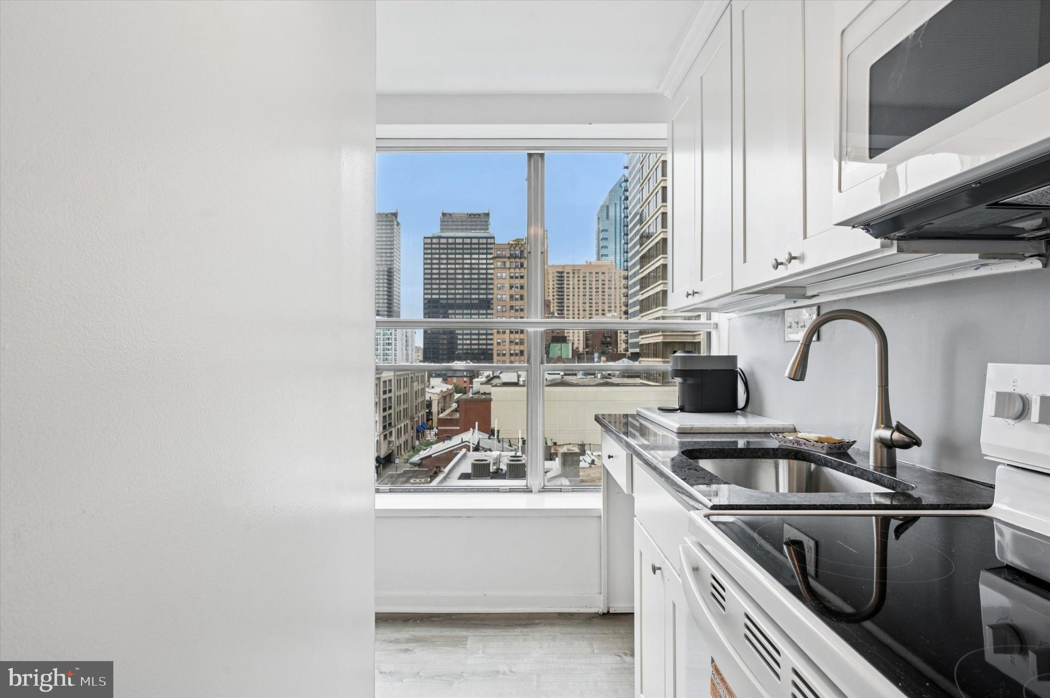 224 West Rittenhouse Square, Unit 715A Philadelphia, PA 19103 - Photo 13 of 47 a kitchen with stainless steel appliances a sink a stove and white cabinets
