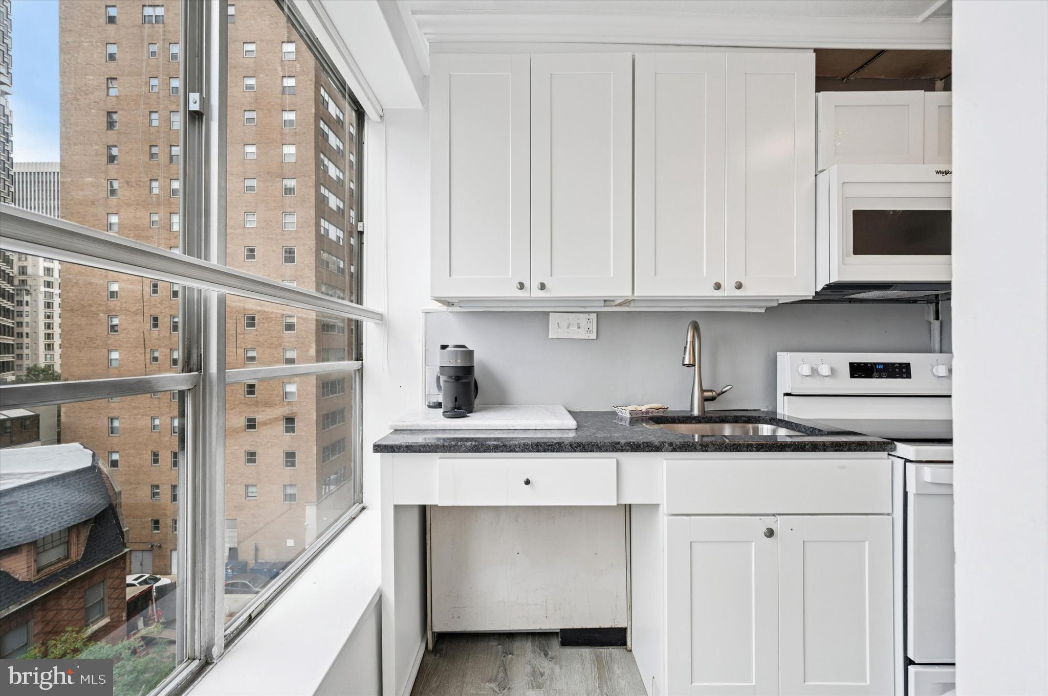 224 West Rittenhouse Square, Unit 715A Philadelphia, PA 19103 - Photo 15 of 47 a kitchen with stainless steel appliances granite countertop a sink and a stove