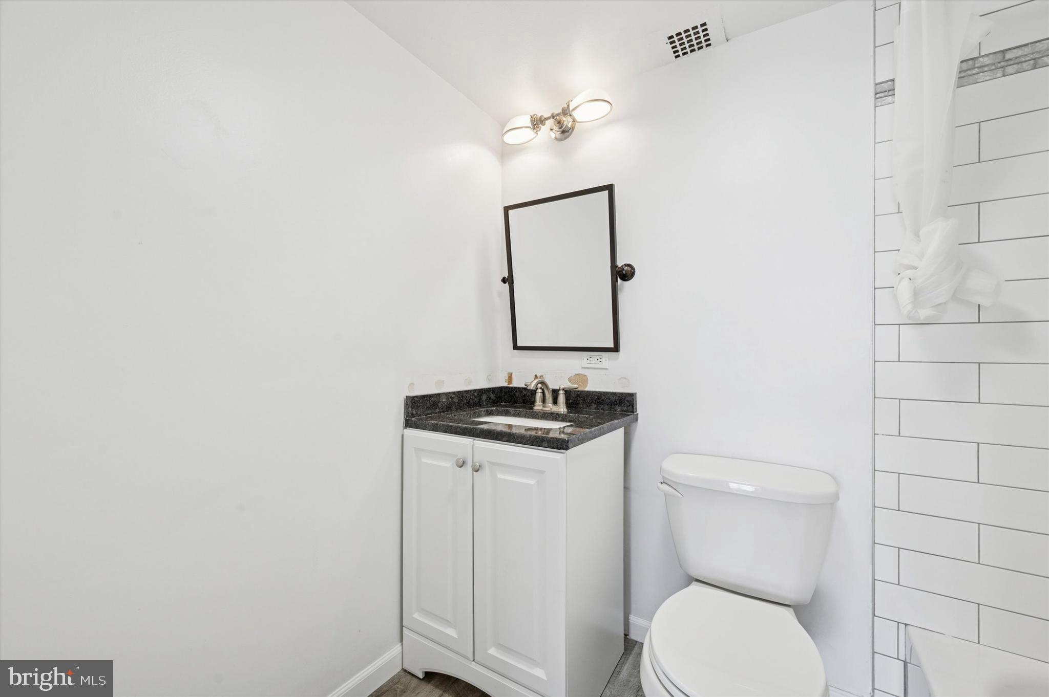 224 West Rittenhouse Square, Unit 715A Philadelphia, PA 19103 - Photo 16 of 47 a bathroom with a toilet a sink and mirror