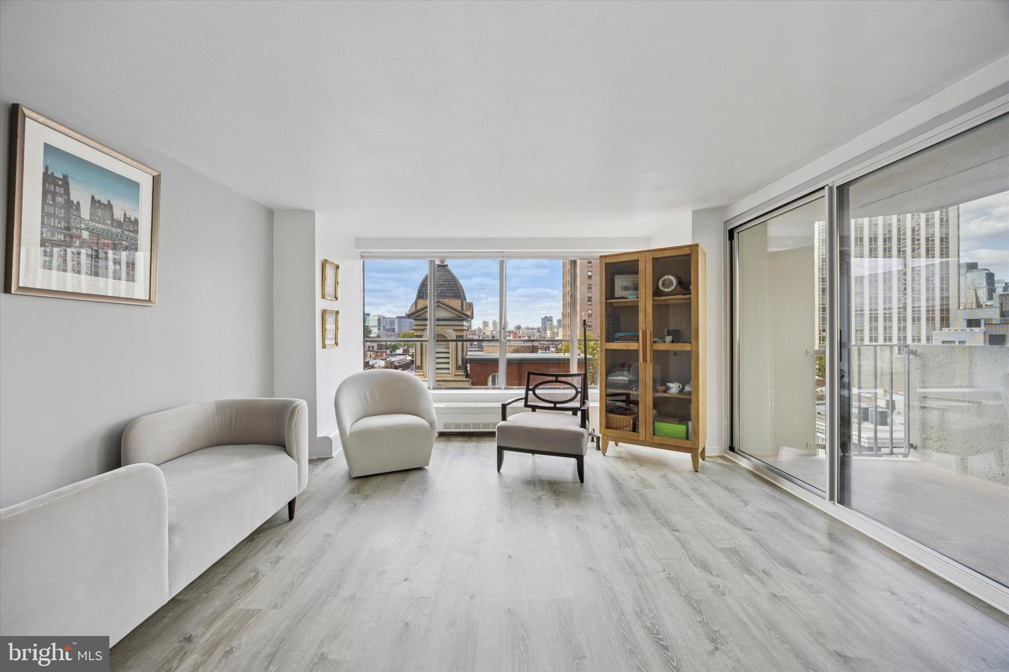 224 West Rittenhouse Square, Unit 715A Philadelphia, PA 19103 - Photo 3 of 47 a living room with furniture and a floor to ceiling window