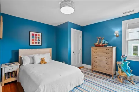 a bedroom with a bed and a book shelf