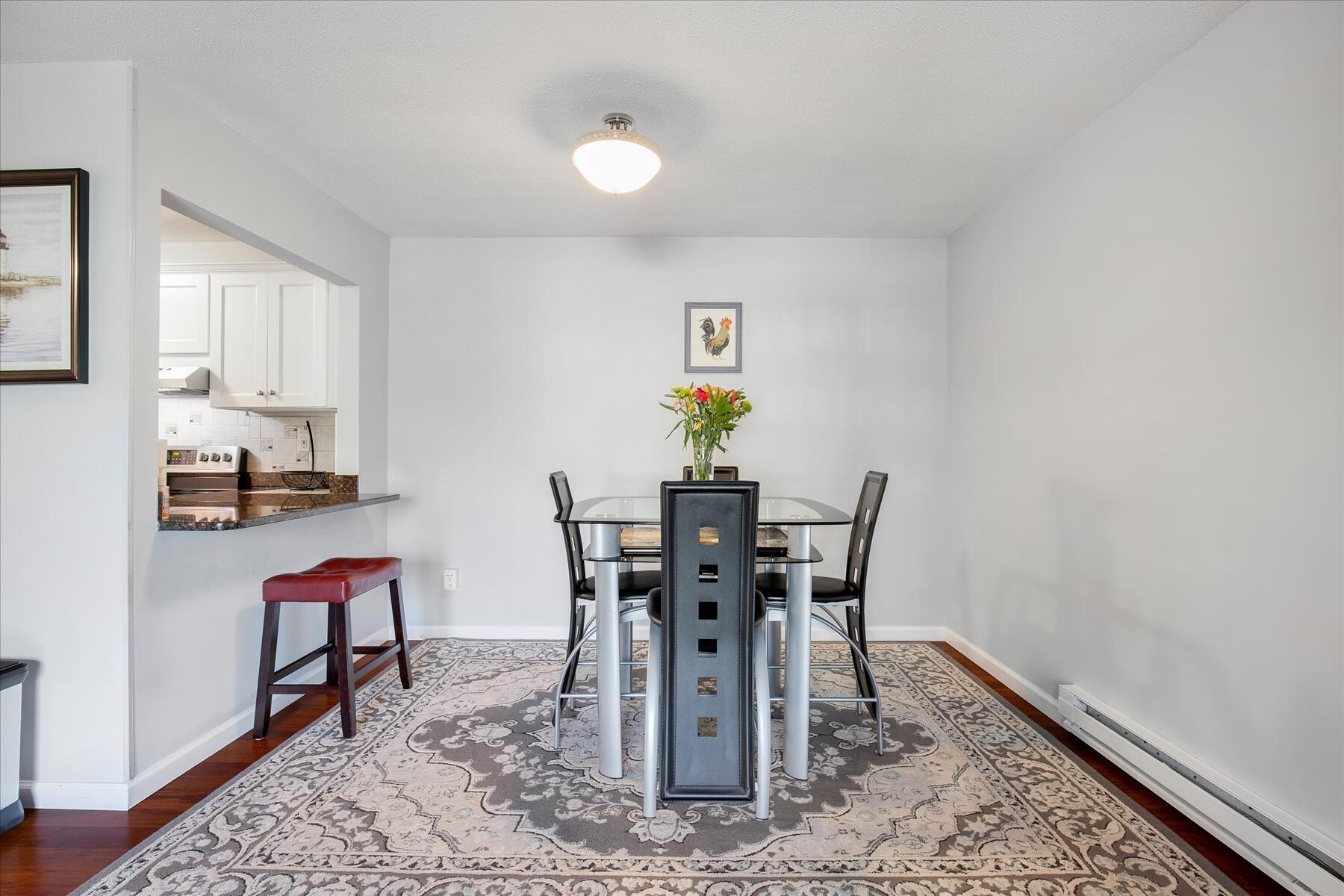 800 Bearses Way, Unit 1EB Hyannis, MA 02601 - Photo 10 of 37 a view of a dining room with furniture and wooden floor