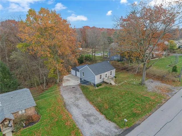a view of a multi story residential apartment building with a yard