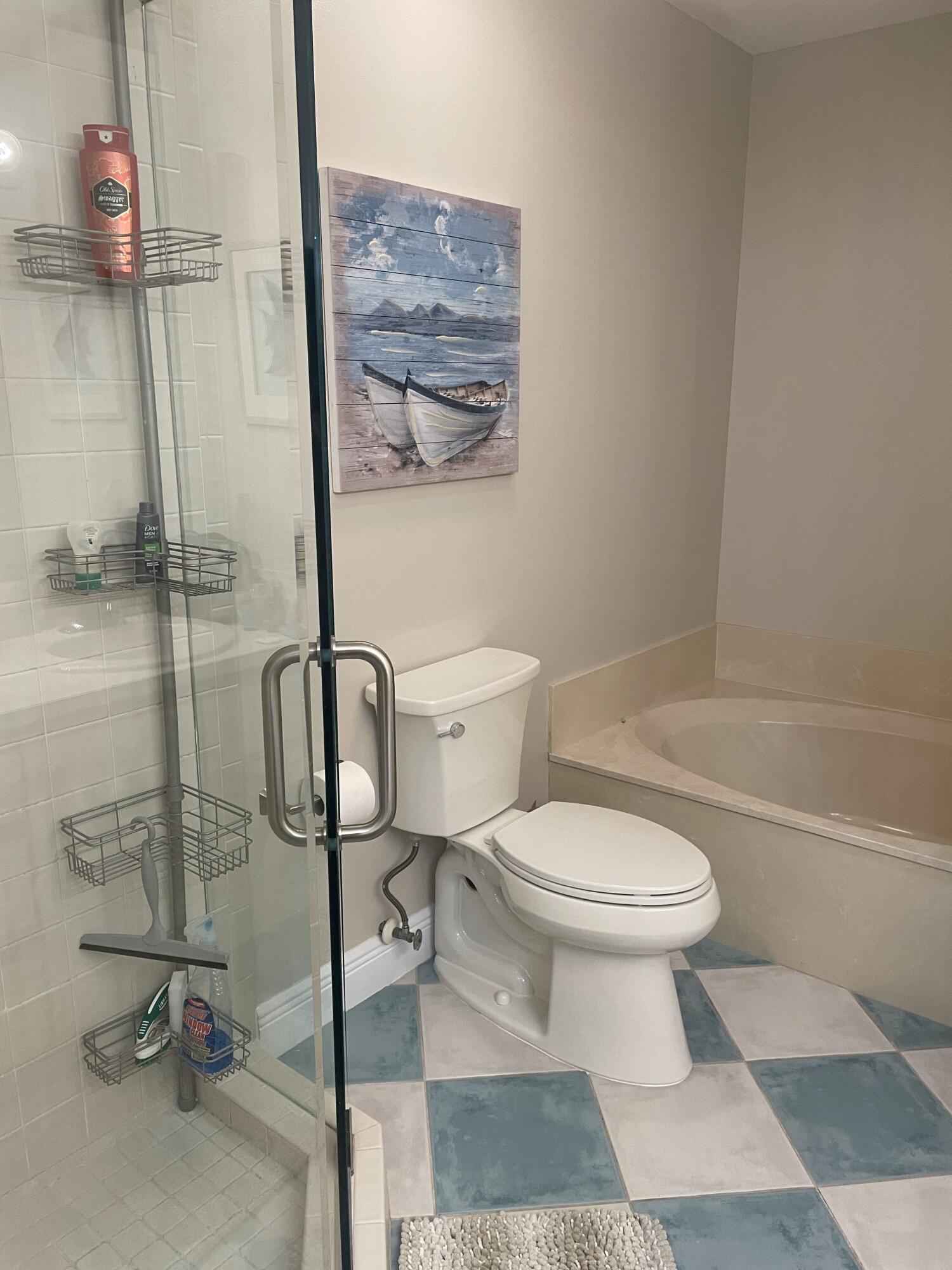 109 Half Moon Circle, Unit A3 Hypoluxo, FL 33462 - Photo 12 of 20 a bathroom with a toilet and a shower