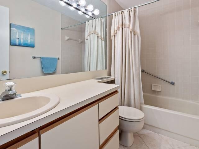 109 Half Moon Circle, Unit A3 Hypoluxo, FL 33462 - Photo 14 of 20 a bathroom with a sink a toilet and shower