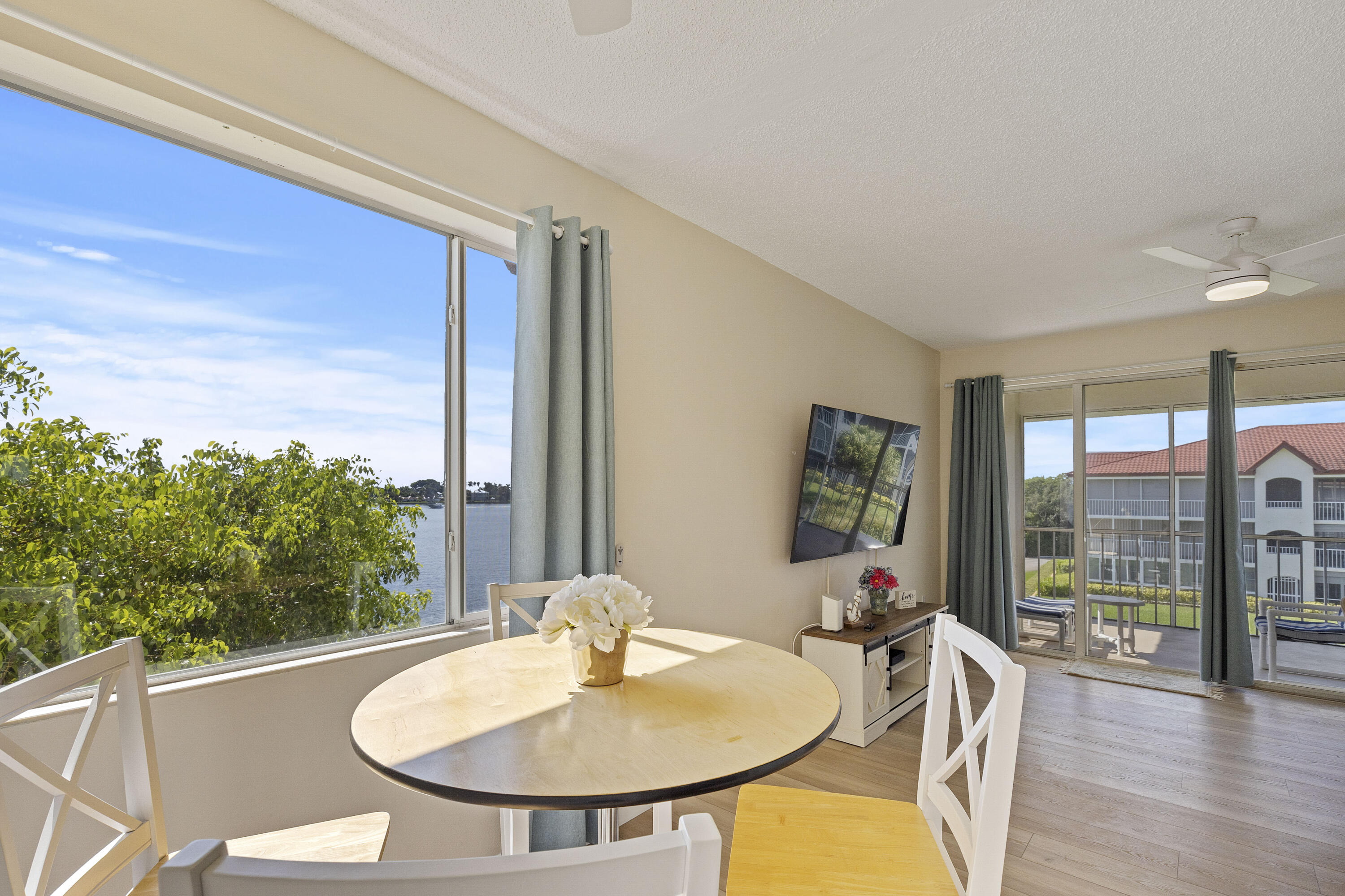 109 Half Moon Circle, Unit A3 Hypoluxo, FL 33462 - Photo 7 of 20 a view of a dining room with furniture window and outside view