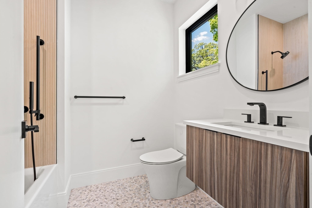 17 Prospect Hill Road Lexington, MA 02421 - Photo 20 of 42 a bathroom with a sink a toilet and a mirror