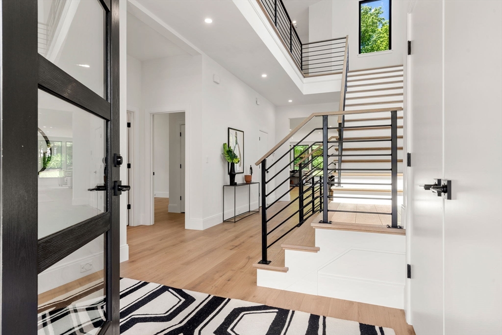 17 Prospect Hill Road Lexington, MA 02421 - Photo 5 of 42 a view of a hallway with wooden floor and stairs