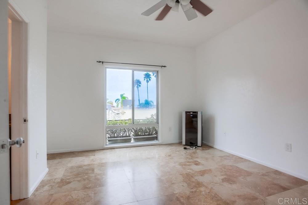 1295 Prospect Street, Unit D La Jolla, CA 92037 - Photo 12 of 24 an empty room with ceiling fan and window