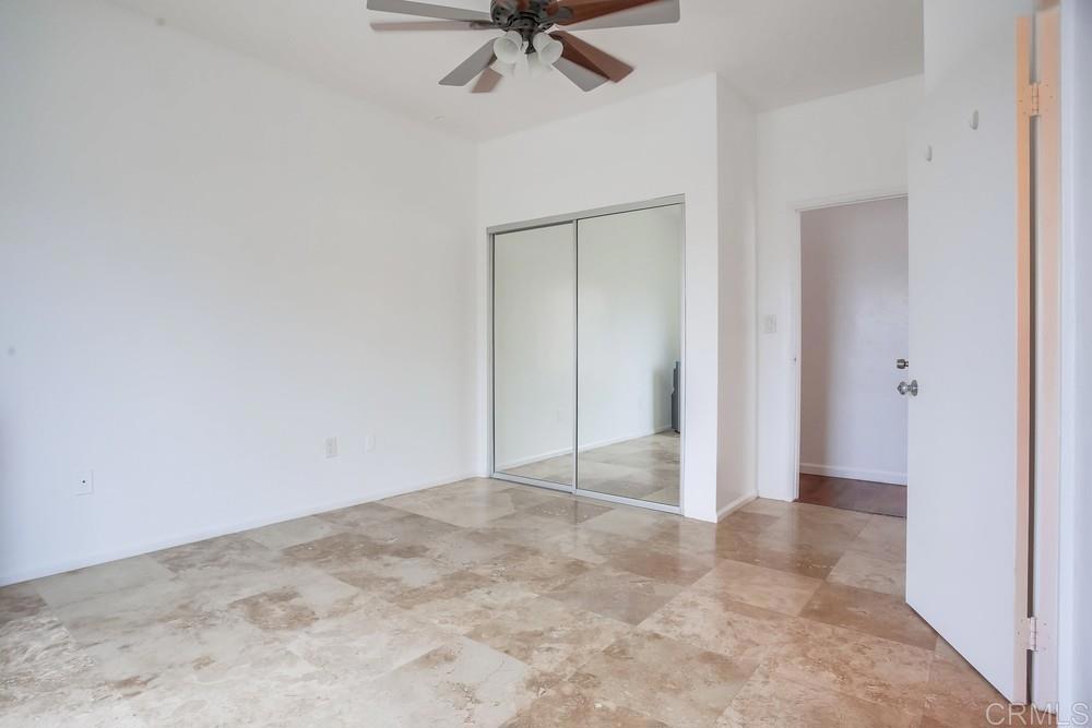 1295 Prospect Street, Unit D La Jolla, CA 92037 - Photo 15 of 24 an empty room with a ceiling fan and carpet