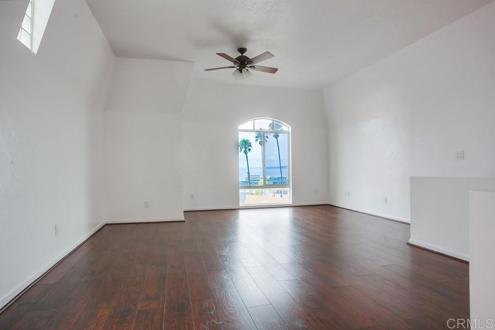 1295 Prospect Street, Unit D La Jolla, CA 92037 - Photo 5 of 24 a view of an empty room with a window and wooden floor