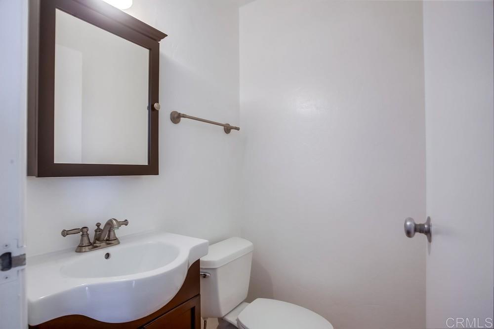1295 Prospect Street, Unit D La Jolla, CA 92037 - Photo 10 of 24 a bathroom with a sink mirror and toilet