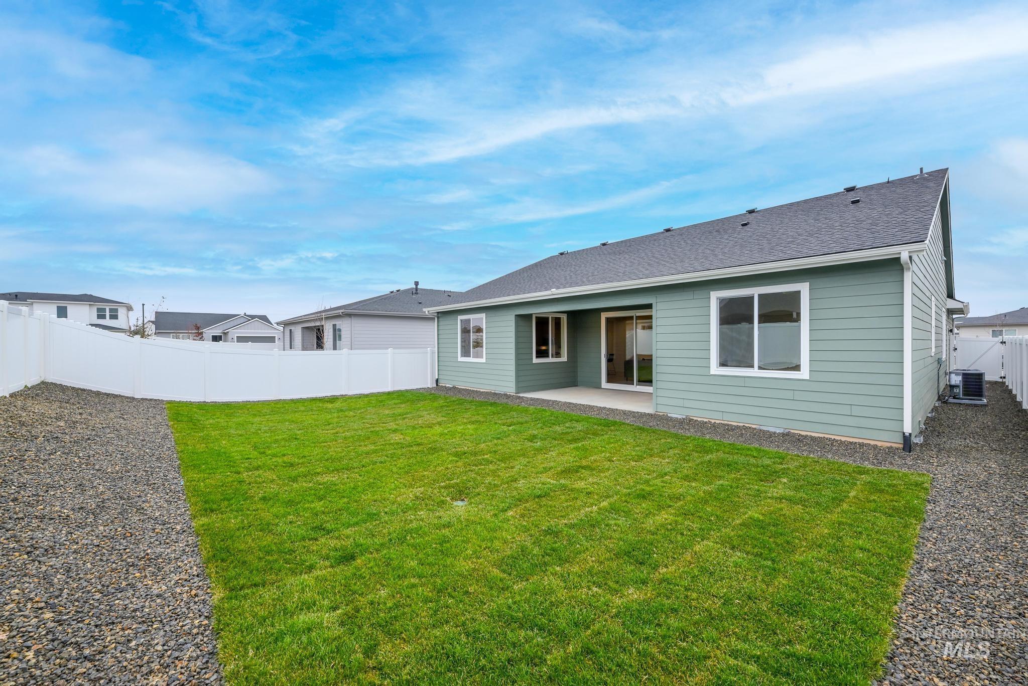 1932 Chokecherry Avenue Middleton, ID 83644 - Photo 11 of 11 Rear view of property with a patio area, a fenced backyard, and roof with shingles