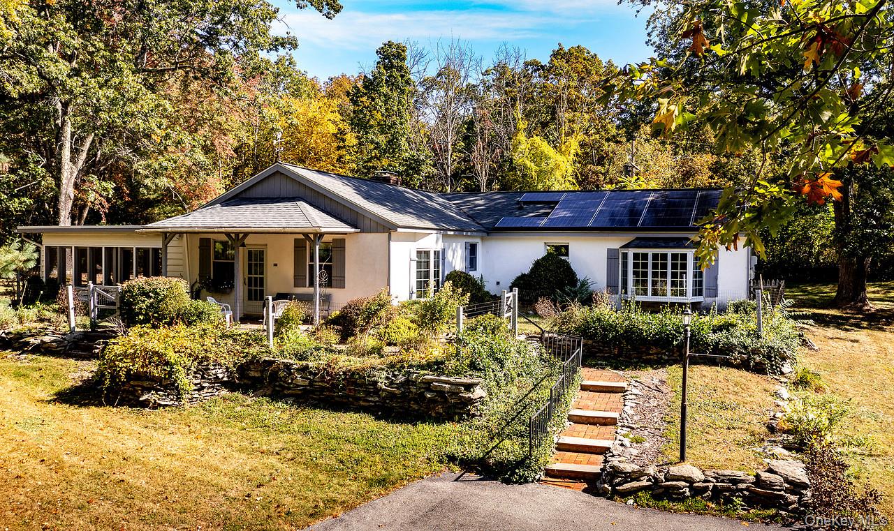 a front view of a house with a yard table and chairs