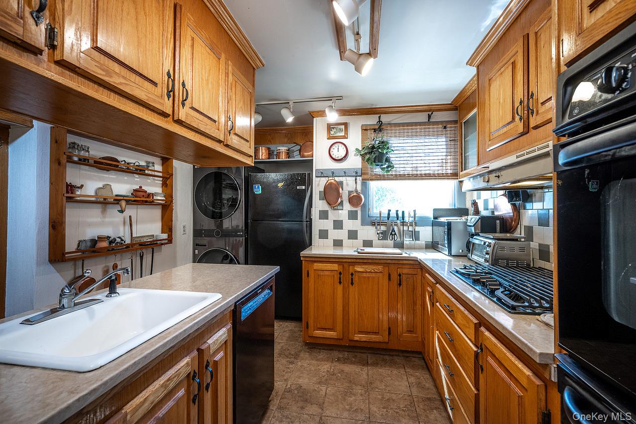 53 Tyrrel Road Pleasant Valley, NY 12569 - Photo 16 of 35 a kitchen with granite countertop a sink stove and refrigerator