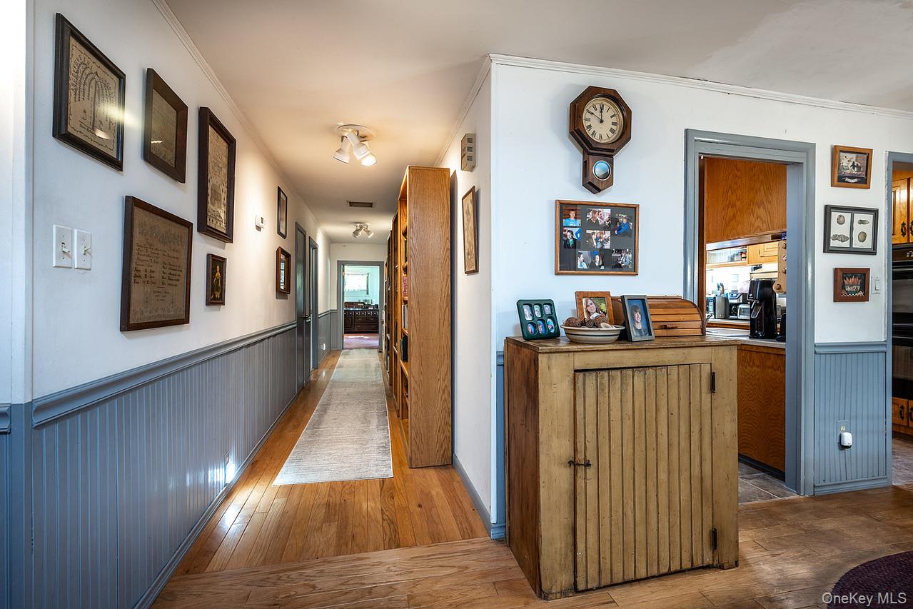 53 Tyrrel Road Pleasant Valley, NY 12569 - Photo 18 of 35 a view of a hallway with wooden floor and a living room