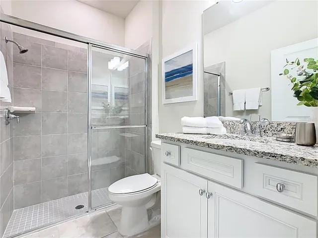 a living room with furniture a flat screen tv and a table