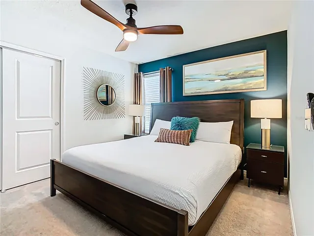 a bedroom with a bed and a television