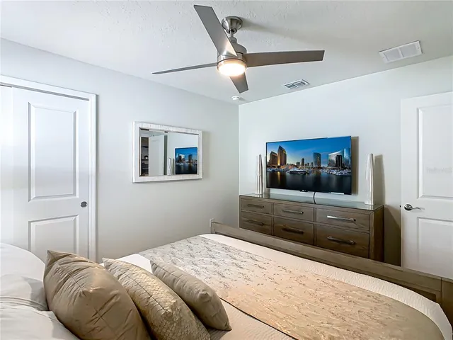 a bathroom with a granite countertop sink mirror and painting on the wall